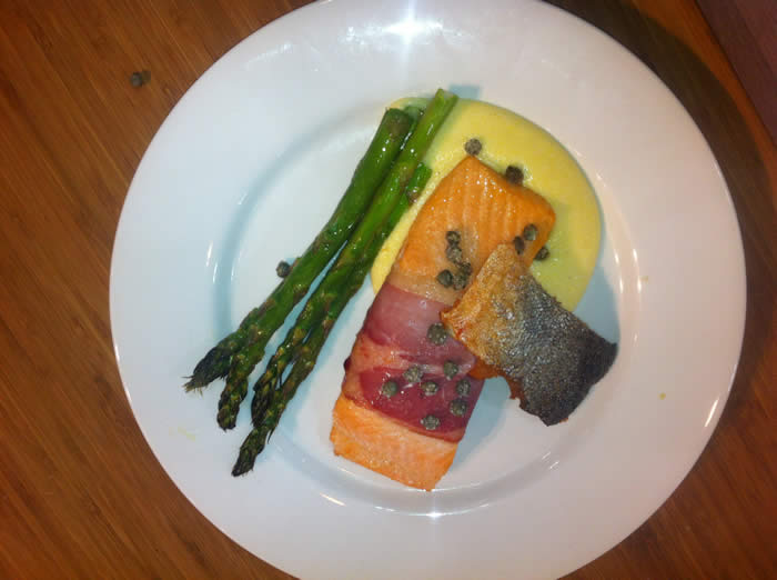 King Salmon Wrapped in Prosciutto with Asparagus, Crisp Capers, ‘Wafer of Skin’ on Soft Polenta